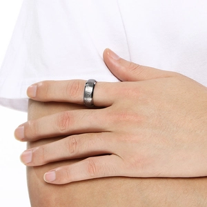 Detailed close-up of a men's silver tungsten ring with vintage Celtic knot patterns