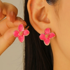Pink floral stud earrings with gold edges and textured four-petal oil-drop design