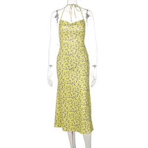 Detail of yellow floral dress showing halter neck, backless design and light fabric