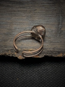 Macro shot of an antique bronze adjustable ring featuring a raw natural stone inlay