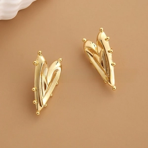 Detail view of gold-plated heart earrings featuring micro-bead edges and vintage finish