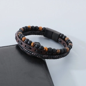 Detail of men's layered leather bracelet with tiger eye beads and black magnetic clasp