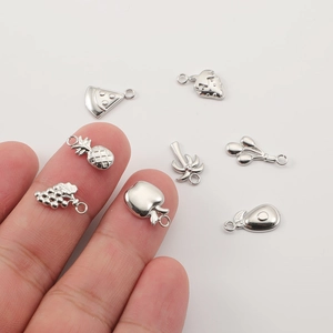 Assorted stainless steel fruit pendants for DIY jewelry shown on a clean white background