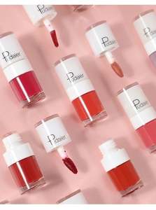 Flat lay of multiple velvet matte lip glazes in various red shades with white caps