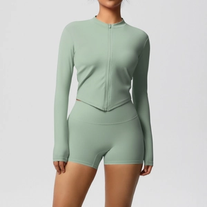 Detail of high-waist fitness shorts and slim-fit zip jacket in sage green yoga set
