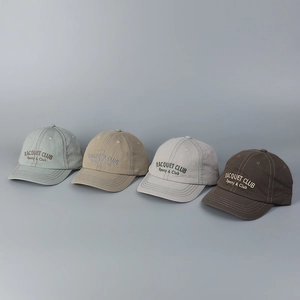 Detail of vintage washed cotton baseball caps in four colors with embroidered letters