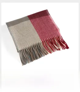 Close-up of fringe tassels on red and beige plaid cashmere-like scarf shawl