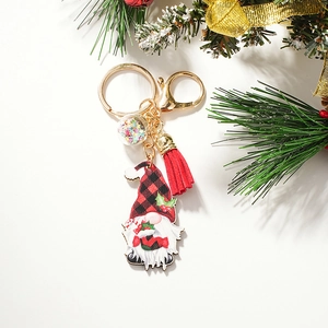 Detail of Christmas gnome keychain with red buffalo plaid hat and festive sequin ball