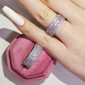 Detail of luxury eternity rings with pink and white cubic zirconia in a velvet box