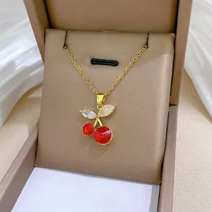 Elegant gold titanium steel necklace featuring a sparkling red cherry pendant with zircons