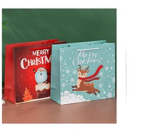 Detail of Christmas gift paper bags featuring Santa and reindeer with festive snowflakes