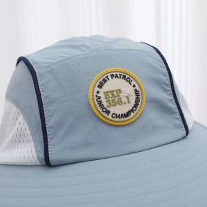 Kids wide brim sun hat in light blue with breathable mesh panels and a lettered patch