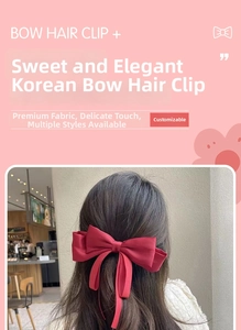 Detail of red satin bow hair clip worn by model for an elegant hair style look