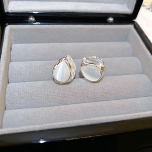 Minimalist silver teardrop cat eye stone earrings displayed in a luxury gray velvet jewelry box