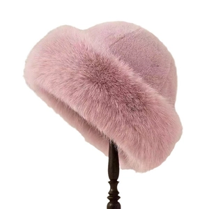 Detail of soft pink faux fur bucket hat featuring premium thick plush texture for winter