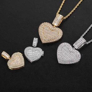 Detail view of gold and silver heart photo pendants with paved zirconia in two sizes