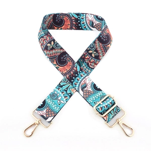 Close-up of adjustable colorful ethnic pattern woven bag strap with gold metal hardware