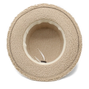Detail of beige fleece bucket hat interior showing adjustable drawstring and soft texture