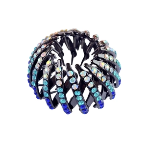 Macro detail of bird nest hair clip featuring blue gradient rhinestones on resin base