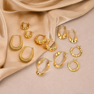 Set of five pairs of 18K gold-plated stainless steel earrings on luxurious gold silk fabric
