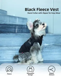 Detail of black polar fleece dog vest with stand collar and Nature logo on stone background