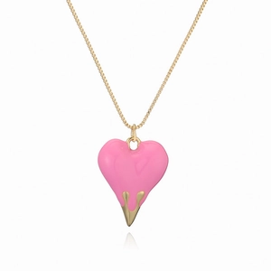 Golden necklace with pink heart flame pendant on a minimalist white background