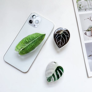 Macro detail of leaf-shaped resin phone griptoks with realistic textures and glossy finish