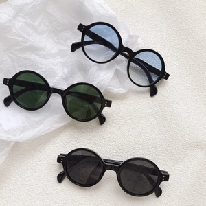 Vintage round frame sunglasses in black with multi-color lenses on white background
