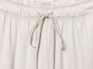 Close-up of elastic waist with drawstring on beige linen trousers for women