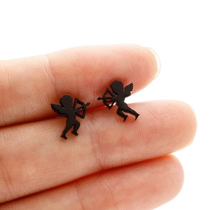 Macro shot of black Cupid silhouette stud earrings on a fingertip for size reference