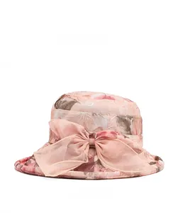 Detailed side view of pink floral sun hat featuring an elegant organza bow decoration
