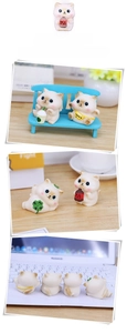 Detail view of four cute lucky cat figurines with colorful accessories for desk decor