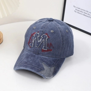 Vintage washed blue denim baseball cap featuring embroidered M logo and star patch