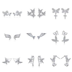 Macro shot of 925 silver earrings with butterfly and star motifs set with cubic zirconia