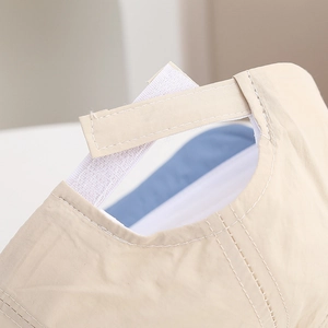 Detail of adjustable Velcro strap on beige quick-dry nylon baby sun hat with blue lining