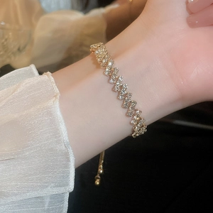 Gold plated wavy clover bracelet with cubic zirconia and adjustable slider clasp