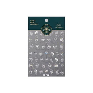 Autocollants nail art nœuds et étoiles irisés M-757 avec effet laser sur fond blanc