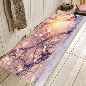 Macro detail of snowy forest scene print on flannel kitchen floor mat over wood