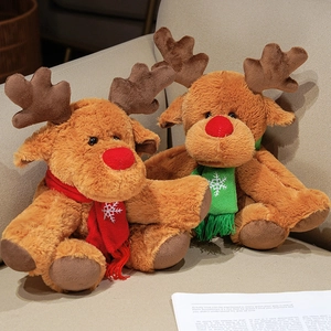 Plush Christmas reindeer toys with red and green scarves on a beige sofa