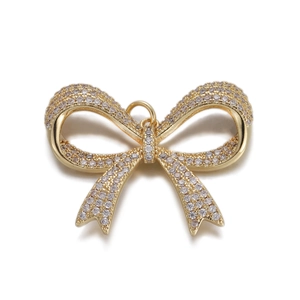 Detailed view of an 18K gold butterfly pendant featuring a full diamond pavé setting