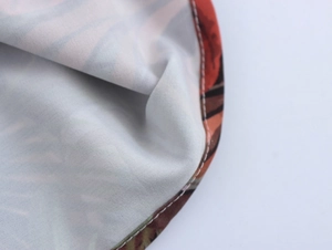 Macro shot of boho print fabric texture and durable stitching on summer dress