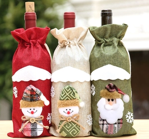 Three burlap Christmas wine bottle covers with 3D snowman and Santa doll decorations