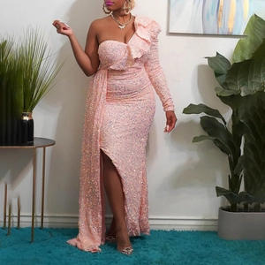 Detail of pink sequin evening dress featuring one-shoulder ruffle and high slit design