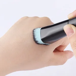 Flat angled foundation brush with soft blue-black gradient bristles and black handle