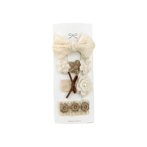 Set of 4 cute beige lace and brown floral bow hair clips for kids on a display card