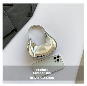 Mini silver metallic moon bag shown next to a smartphone for size comparison