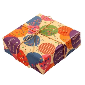 Birthday gift box with colorful balloon patterns and rustic hemp rope on white background