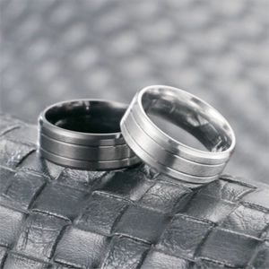 Macro shot of matte titanium steel rings with three grooves on leather texture