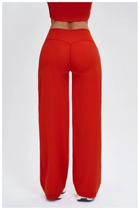 Detail view of red high-waisted wide-leg sweatpants showing fabric texture and loose fit