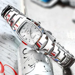 Close-up of silver tonneau quartz watch with stainless steel band and crystal markers
